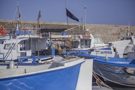 Boats moored at sunset in Porticello, Sicilyの写真素材