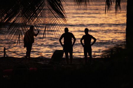 Silhouette of Caribbean people at sunset in Dominicus, Dominican Republicの写真素材