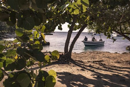 BAYAHIBE, DOMINICAN REPUBLIC 23 DECEMBER 2019: Boats on the sea in Bayahibe surrounded by typical vegetationの写真素材
