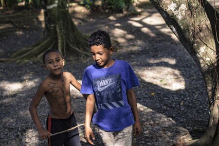MONTANA REDONDA, DOMINICAN REPUBLIC 27 DECEMBER 2019: Young Dominican boys in a poor farmのeditorial素材