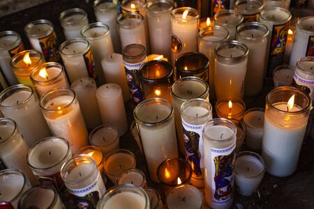 Many religious candles inside a catholic churchのeditorial素材