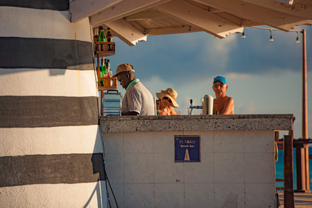 DOMINICUS, DOMINICAN REPUBLIC 6 FEBRAURY 2020: Dominican bartender prepares a cocktail on the beach