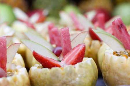 Trays full of fruit slices used as a dessert in a buffet