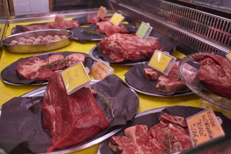 Various Meat cuts exposed in the butchery fridge counterの写真素材
