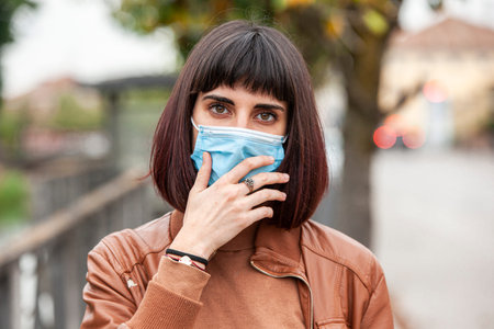 Portrait of a Girl with medical mask outdoor during covid quarantine in Italy