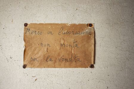 Old sign handwritten in Italian in an abandoned building in Italyの写真素材