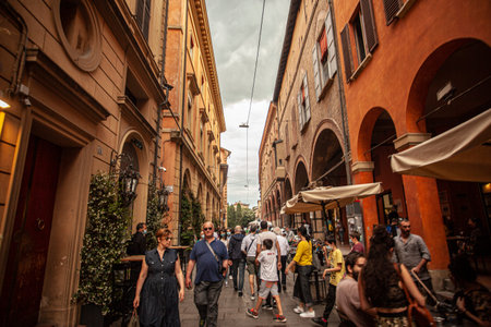 BOLOGNA, ITALY 17 JUNE 2020: Bologna alley detail with people walking