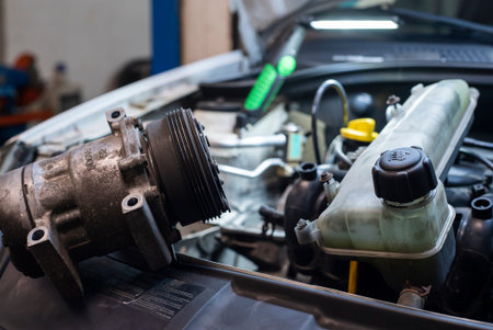 Automobile engine with disassembled parts in a Workshop