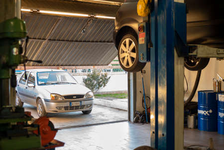 MILAN, ITALY 17 FEBRUARY 2021: Mechanic performs maintenance on the car in the workshopのeditorial素材
