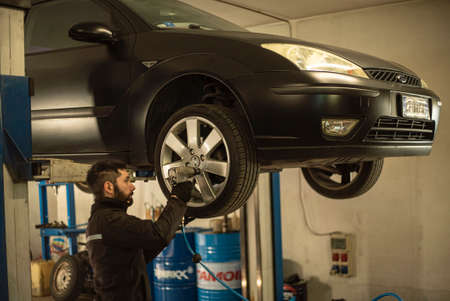 MILAN, ITALY 17 FEBRUARY 2021: Mechanic performs maintenance on the car in the workshopのeditorial素材
