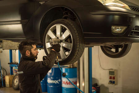 MILAN, ITALY 17 FEBRUARY 2021: Mechanic performs maintenance on the car in the workshopのeditorial素材