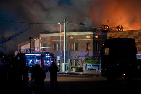 VILLANOVA DEL GHEBBO, ITALY 23 MARCH 2021: House burning at night with firefightersのeditorial素材