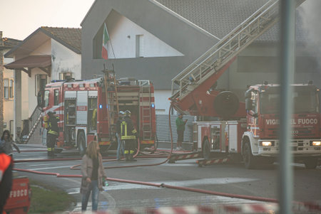 VILLANOVA DEL GHEBBO, ITALY 23 MARCH 2021: House burning at night with firefighters