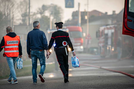 VILLANOVA DEL GHEBBO, ITALY 23 MARCH 2021: House burning at night with firefightersのeditorial素材