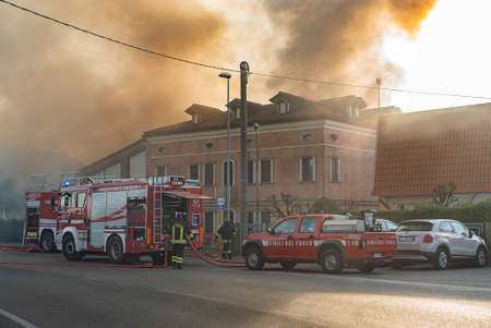 VILLANOVA DEL GHEBBO, ITALY 23 MARCH 2021: Fire on the street with firefightersのeditorial素材
