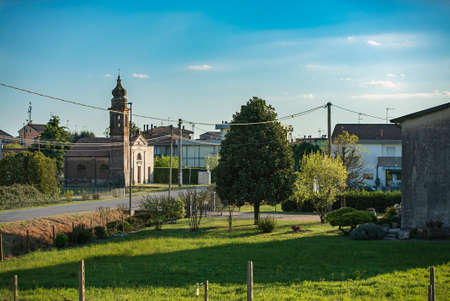 Beautiful garden near the street under a blue sky in a village in a sunny dayの写真素材