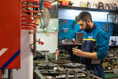 MILAN, ITALY 6 MAY 2021: Mechanic at work in the workshopのeditorial素材