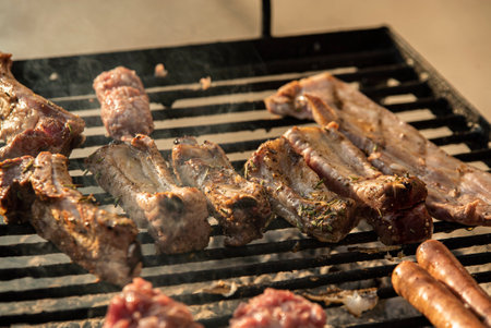 Grilled ribs detail on the grill with smoke cookingの写真素材