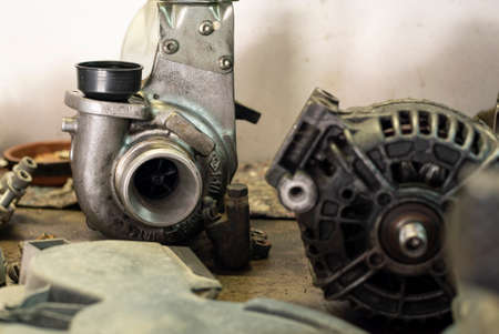 Worn turbine and alternator in a workshop benchの写真素材