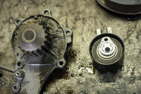 Old car engine parts in a workshop benchの写真素材