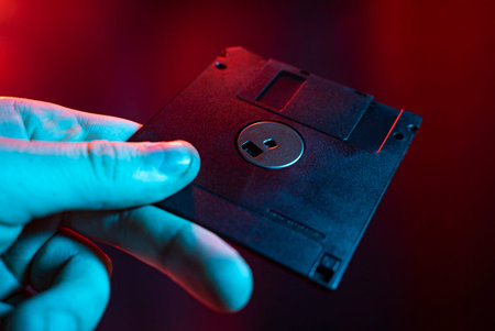 Floppy disk detail in hand with colored lights