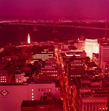 SAN FRANCISCO, UNITED STATES MAY 1970: Embarcadero and Bay Bridge at night in 70's