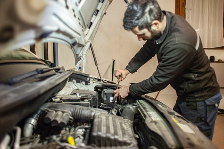 MILAN, ITALY 24 APRIL 2022: Mechanic repairs car detail