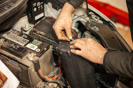 MILAN, ITALY 24 APRIL 2022: Mechanic mounts car engine hydrogen system