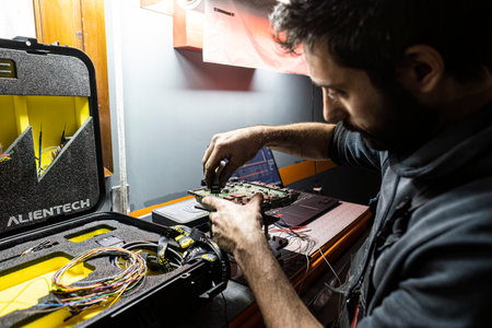 Rome, Italy 29 september 2022: Mechanic performs car ecu remapping. Detail of Car ecu bench reading method for remapping and power Increase. Tuning Car Ecu electronic.の写真素材
