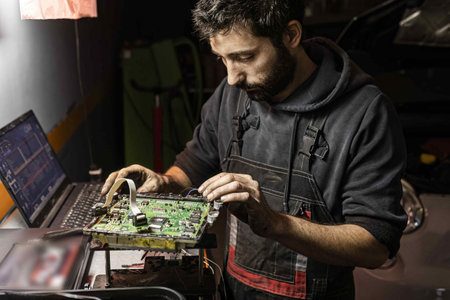 Mechanic performs car ecu remapping. Detail of Car ecu bench reading method for remapping and power Increase. Tuning Car Ecu electronic.の写真素材