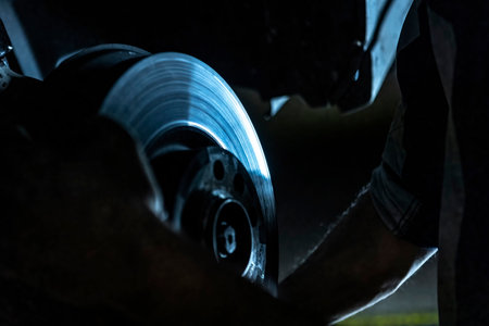 Mechanic hands detail during a maintenance of car brakesの写真素材