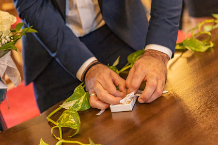 Groom takes wedding rings during the ceremony sceneの写真素材