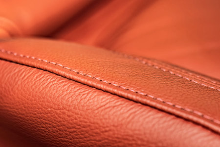 Red leather seat stitching of a modern car detail