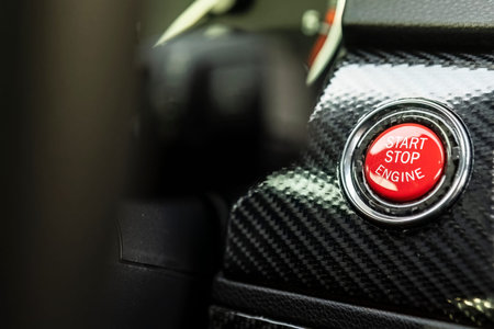 Red engine start button detail. Car dashboard with focus on red engine start stop button, car...