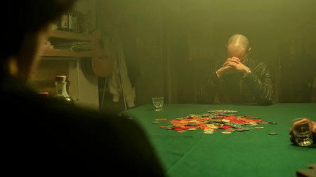 An excited poker player wins the game, reveals his cards and takes all the poker chips scattered on the table. Winning in gambling.の写真素材