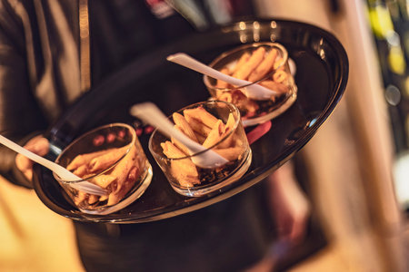 A close-up shot of a tray featuring three mini pasta appetizers, perfect for entertaining guests.の写真素材