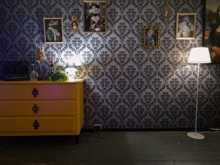 Room filled with colorful furniture, enhanced by vintage wallpaper creating a retro vibe.の写真素材
