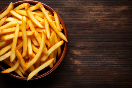 Top view of delicious crispy French fries, perfectly arranged with space for text.の素材