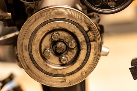 Photo focusing on the intricate pulleys of a car engine, highlighting their essential role in function.の写真素材