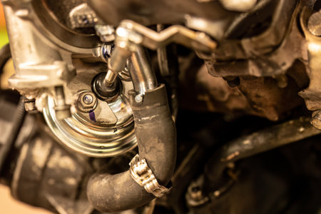 Close-up photo of a wastegate valve in a turbocharged car engine, highlighting precision and technology.の写真素材