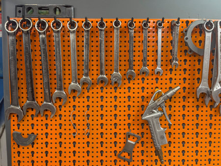 A photo showscasing a variety of wrenches neatly arranged and hanging on a wall.