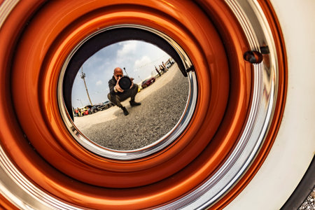 Close-up of a vintage Chevy pickup's chrome wheel, showcasing classic American automotive design.