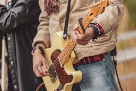Crowd of individuals standing together, each holding a guitar. They are united in their musical...