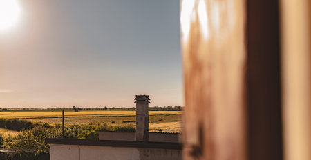 Scenic view of the Po Valley countryside during summer seen through a window, showing expansive...