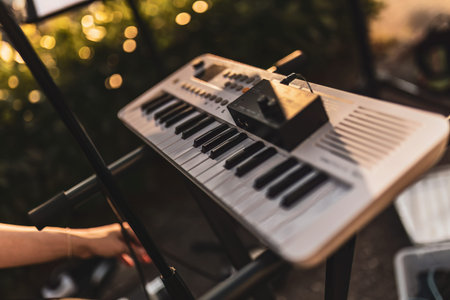 Milan, Italy 12 June 2024: Close-up of an electronic keyboard set up for an outdoor performance with blurred bokeh background.のeditorial素材
