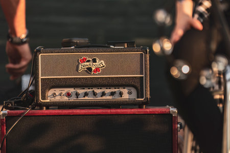 Milan, Italy 12 June 2024: Close-up of a Blackheart guitar amplifier placed on a red speaker cabinet, ready for an outdoor performance.のeditorial素材