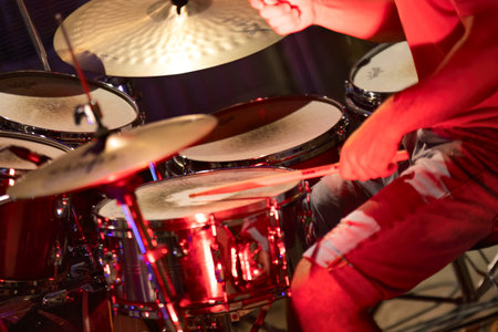 Milan, Italy 12 June 2024: dynamic close-up shot of a drummer in action, captured during a live performance. The image focuses on the drum kit, with visible motion blur from the drummer's handsのeditorial素材