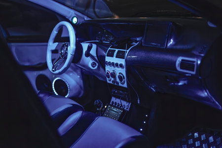 Adria, Italy 30 July 2024: A futuristic car interior with advanced technology and blue ambient lighting, showcasing modern automotive design.のeditorial素材