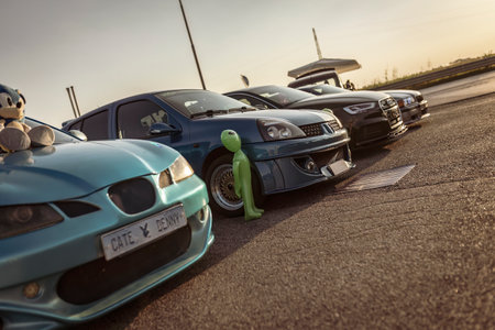 Adria, Italy 30 July 2024: Various tuning cars parked at a gathering with a focus on the car designs and details.のeditorial素材