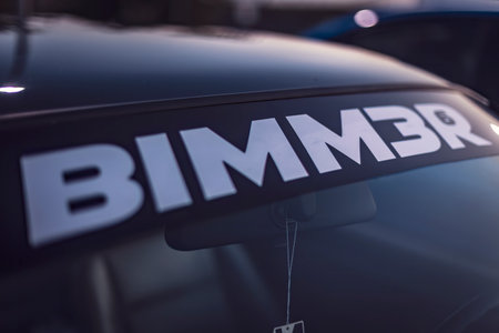 Adria, Italy 30 July 2024: A closeup view of a Bimmer sticker on a car windshield, highlighting automotive culture and branding.のeditorial素材
